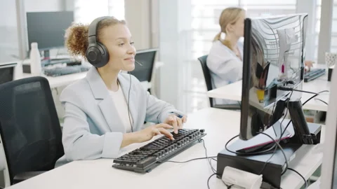 Diverse employees in a contemporary office using technology to collaborate and Stock Footage 280822338