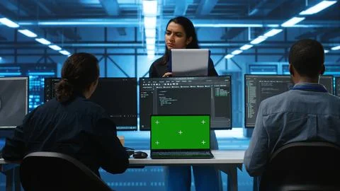 Diverse employees in data center using chroma key notebook Foto stock