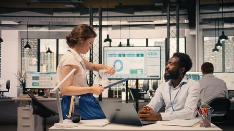 Diverse employees reviewing data analysis and reporting in office Stock Photos