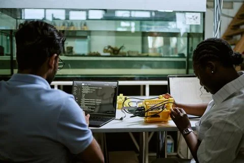 Diverse Engineers Coding and Testing Underwater Robotics in Laboratory Stock Photos