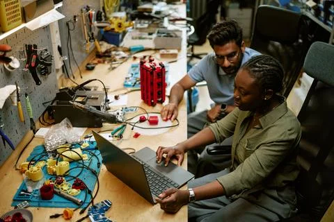 Diverse Engineers Developing Hardware Components on Laptop in Workshop Stock Photos