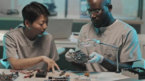 Diverse Engineers Discussing Computer Hardware in Lab Stock Footage 170124631