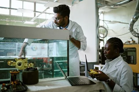 Diverse Engineers Testing Underwater Robot in Laboratory Tank Stock Photos