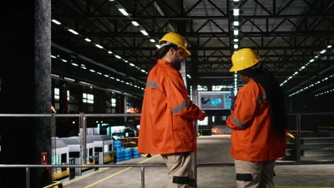 Diverse engineers, turbine asset component, data on laptop, machinery hall Stock Footage 330089186