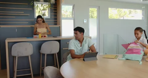 Diverse family finalizing adoption process home at modern home with tablet and 動画素材 316740773