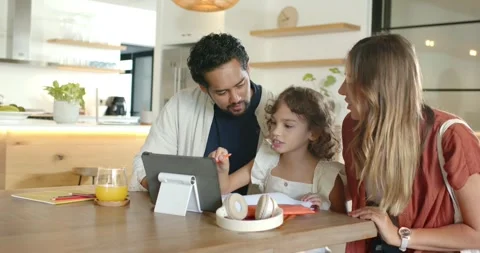 Diverse family at kitchen table responding to tablet, using red stylus and Video stock 342494864