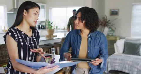 Diverse female friends talking, using tablet, working at home, in slow motion Stock Footage 340971514