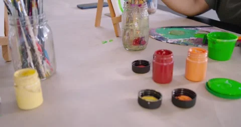 Diverse female painters at studio dipping brush and mixing green on palette, Stock Footage 337238690