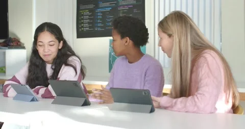 Diverse female students using tablets and discussing code after leftmost Stock Footage 340656127