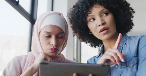 Diverse female team in hijab checking tablet for work at office window, right Stock Footage 345818951