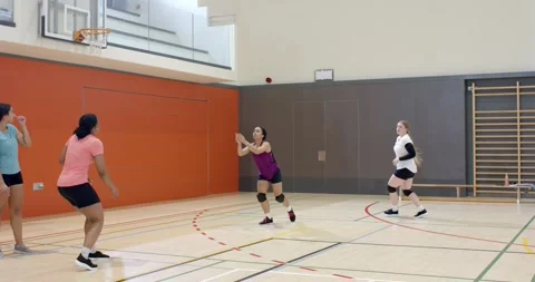 Diverse female team practicing volleyball bumping and digging after teammate Vidéo 345070515