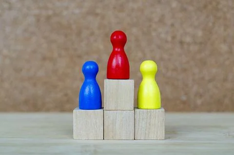 Diverse figures positioned on graduated platforms representing fairness, in.. Stock Photos