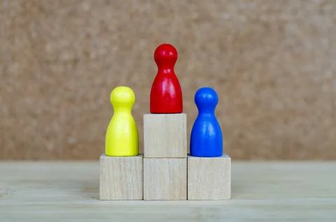 Diverse figures positioned on graduated platforms representing togetherness.. Stock Photos