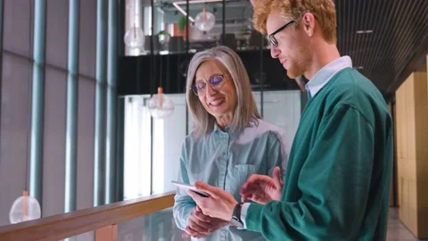 Diverse friendly coworkers talking using digital tablet, discussing project. Stock Footage 201860450