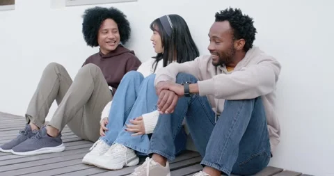 Diverse friends chatting, left man starting talk while others listening, Stock-Footage 345618340