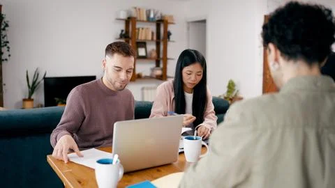 Diverse friends collaborating on project using technology at home Stock Photos