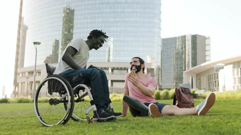 Diverse friends with disability having fun using mobile phone at park city Video stock 197376839