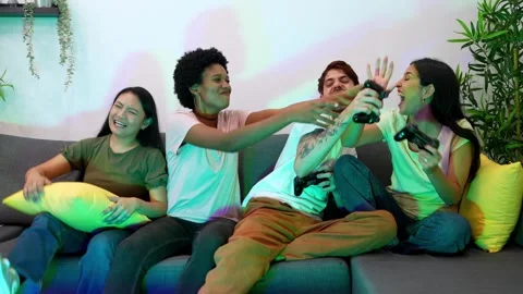 Diverse Friends Having Fun Playing Video Games on Couch Stock Footage 264029903