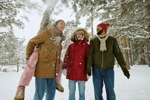 Diverse Friends Having Fun Playing in Snowy Winter Forest Stock Photos