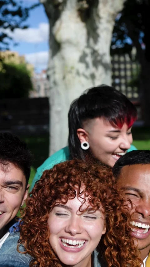Diverse friends smiling at camera while filming POV selfie video. Vertical video Stock Footage 312240637