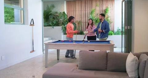 Diverse friends taking break shot on pool table for fun in rec room, alternating Stock Footage 341089717