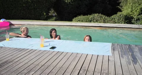 Diverse gals in bikinis seeing cam shadow, woman jumping into pool, surfacing, Stock Footage 342494400