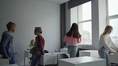 Diverse girls entering programming classroom during break Stock Footage 142495405
