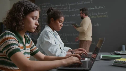 Diverse Girls Writing Computer Code on Laptops at School Lesson Stock Footage 318715907