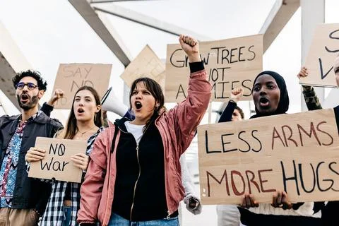 Diverse group of activists people protesting against war and violence. Stock Photos