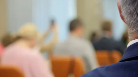 A diverse group of audience members actively engaged in a lively discussion Stock Footage 284908349