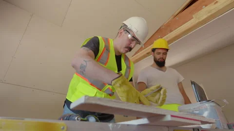 A Diverse Group of Builders Collaborating Effectively at a Busy Construction Stock Footage 305447045