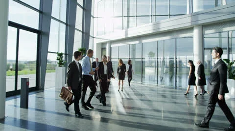 Diverse group of business people in a light and modern office building Stock Footage