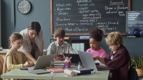 Diverse Group of Children Learning Coding with Teacher in Classroom Stock Footage 339203298