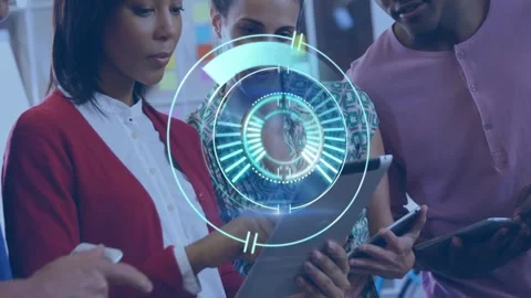 Diverse group collaborating with digital interface animation over tablet in Stock Footage 330292052