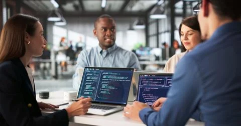 Diverse Group Of Engineers Collaborating On Software Development In Office. Stockfoto's