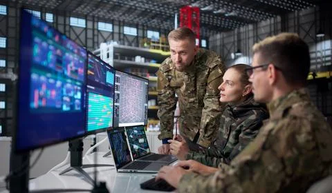 Diverse Group Of Engineers Uses Computers To Design Rocket Parts. Stock Photos