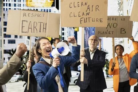 Diverse group of environmental activists marching for planet Earth Stock Photos