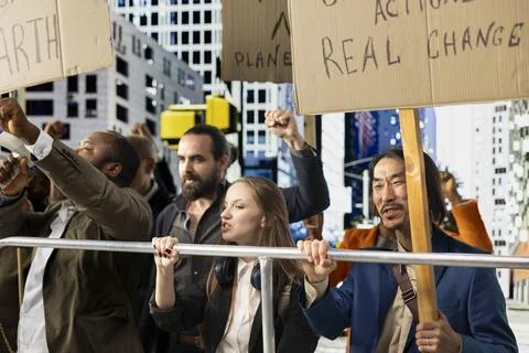 Diverse group of environmental activists marching for planet Earth Stock Photos