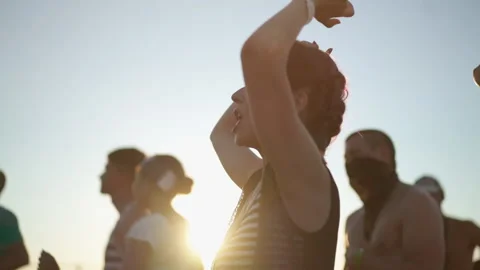 Diverse group of fans dancing at openair live rock concert. Asian woman jump at Stock Footage 144053101