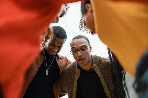 Diverse group finding support in huddle Stock Photos