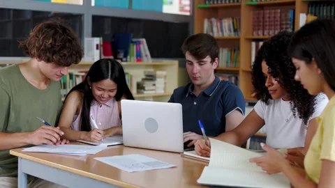 Diverse group of five high school students working together at library Stock Footage 308654292