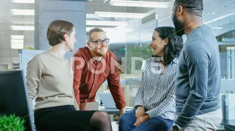 Diverse Group of Four Talented Young Professionals Having Team Conversation Stock Photos