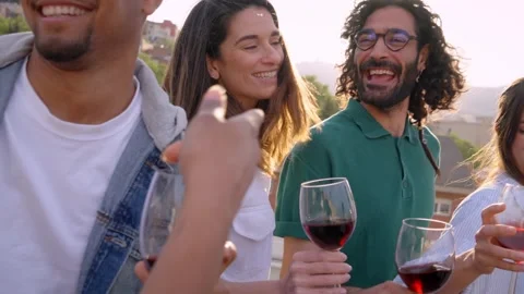 Diverse group of friends dancing and singing celebrating rooftop party at sunset Stock Footage 243083397