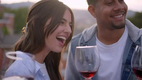 Diverse group of friends dancing and singing celebrating rooftop party at sunset Stock Footage 243608178