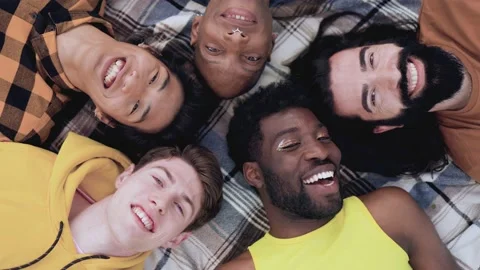 Diverse group of friends having fun together outdoor lying in circle  Stock Footage 201890867