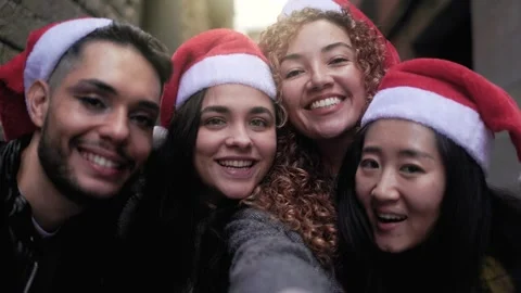 Diverse group of friends having fun celebrating Christmas on city street  Stock Footage 255136877