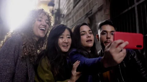 Diverse group of friends having fun taking self portrait in city street. Travel  Stock Footage 276484094