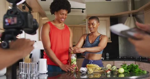 Diverse group of friends making culinary video blog in kitchen Stock Footage 340971352