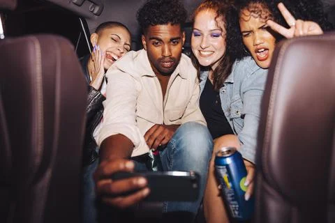 Diverse group of friends taking a selfie in a car Stock Photos