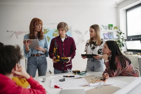 Diverse group of high school students with robotics project in classroom. Stock Photos